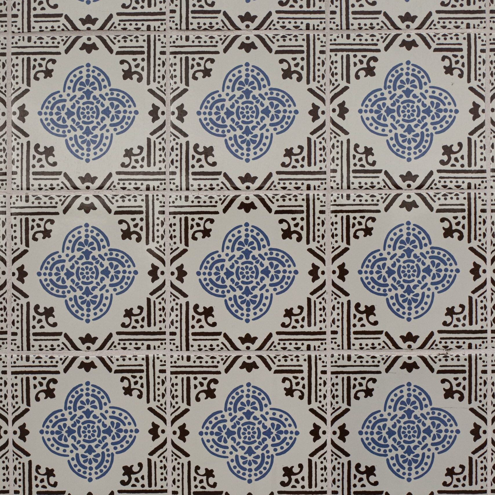 Classic Lisbon azulejos with intricate blue and black floral designs.